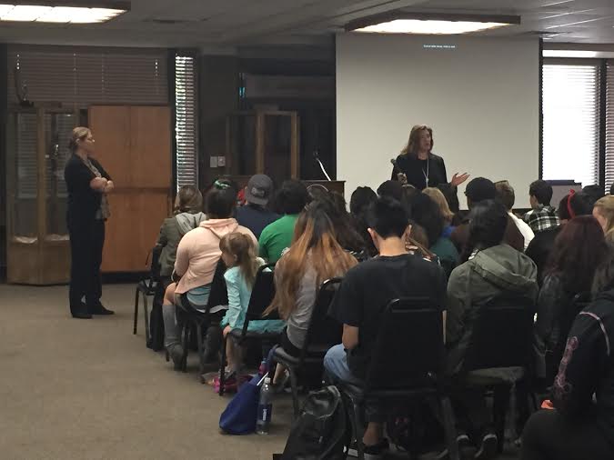 Jami Brown and Amber Casolari speak to student about the gender wage gap in the Bradshaw Building's Hall of Fame room on May 6. (James H. Williams | Viewpoints)