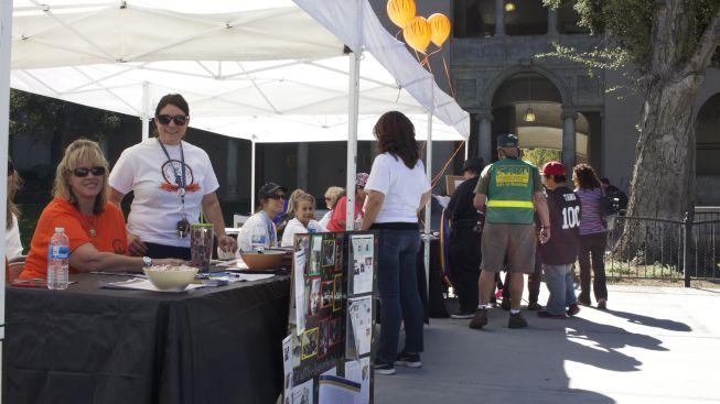 Carol Wohlke (far left) and Whitney Ortega represent Cal Works, Foster Kinship and Care and Guardian Scholars. Members welcomed RCC visitors, handed out fliers and celebrated past years of service to foster youth at RCC’s Centennial Celebration.