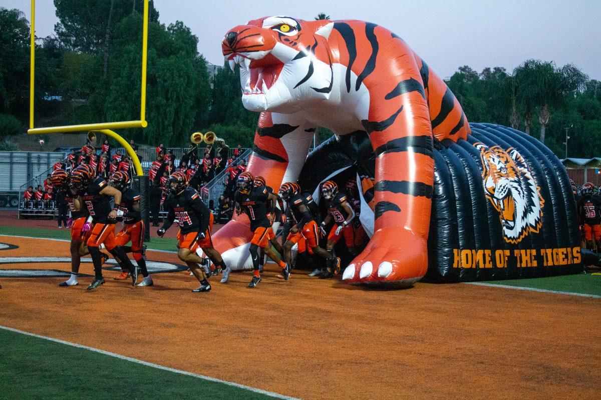 The RCC Tigers enter the field ahead of conference matchup against Cerritos, at home during Breast Cancer Awareness night for the home team. (Brian Calderon | Viewpoints)