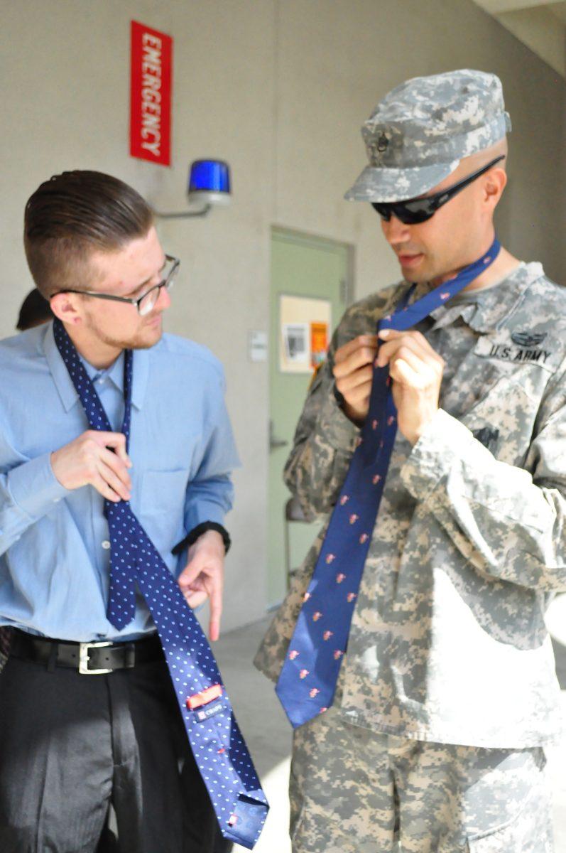 Recruiters help students learn to tie their ties to improve their chances of being hired in the RCC job fair April 25. 