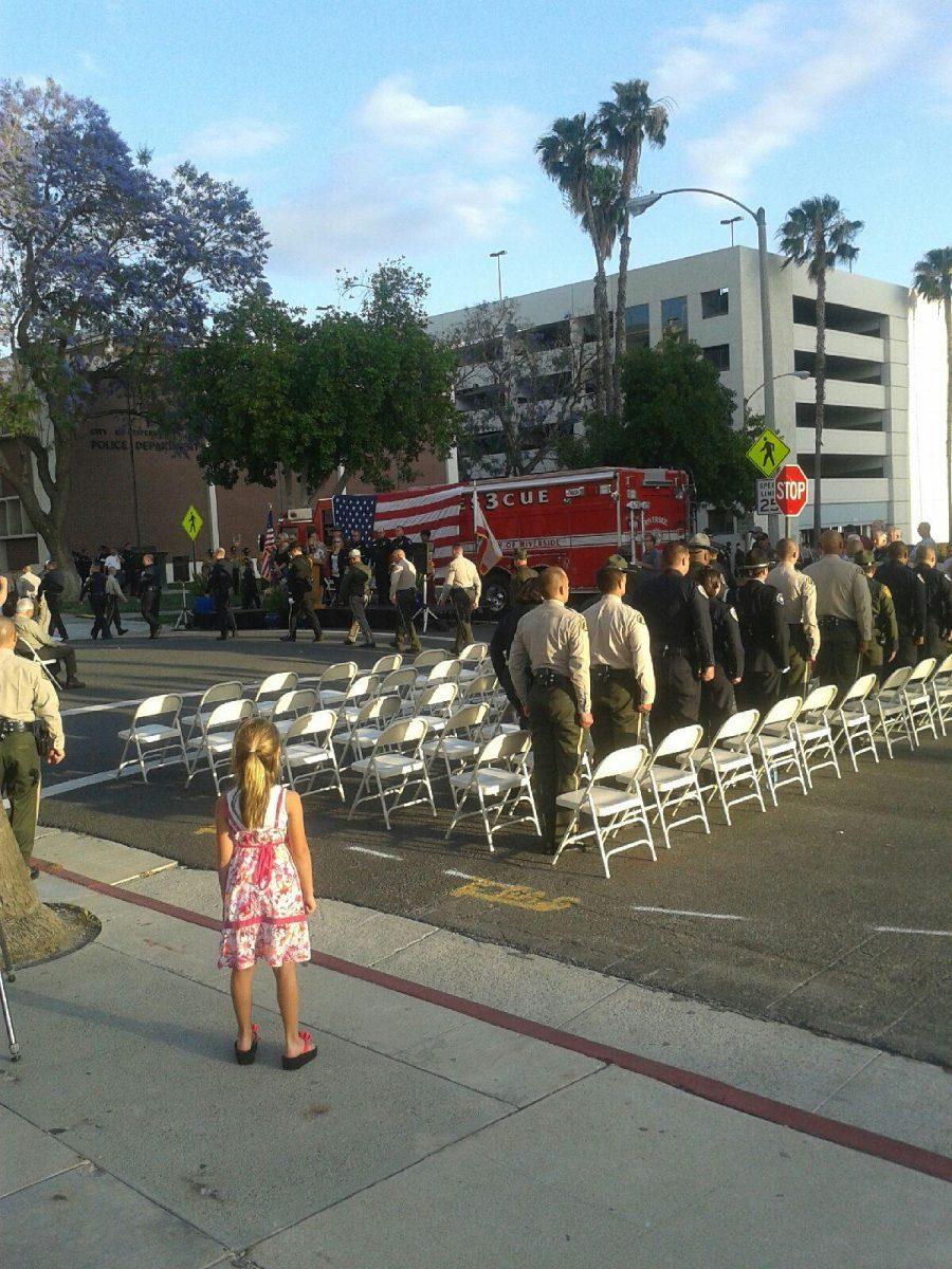 Remember: Officers honor fallen comrades in a ceremony at the “Safe in his Arms Memorial,” while family members take the mood to heart May 19. 