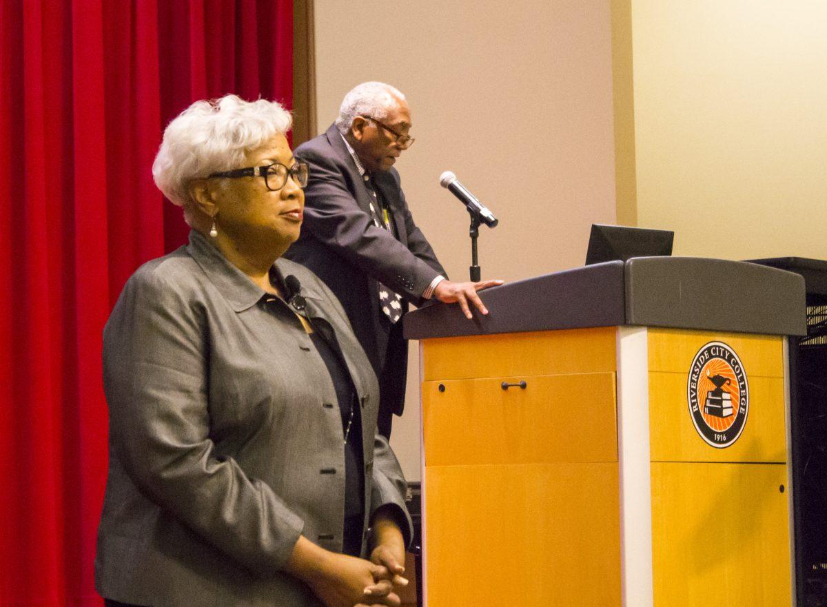 Proud: President Wolde-Ab Isaac introduces Kathryn Jeffery from the stage in the DL Auditorium while Jeffery stands at audience level May 13. 