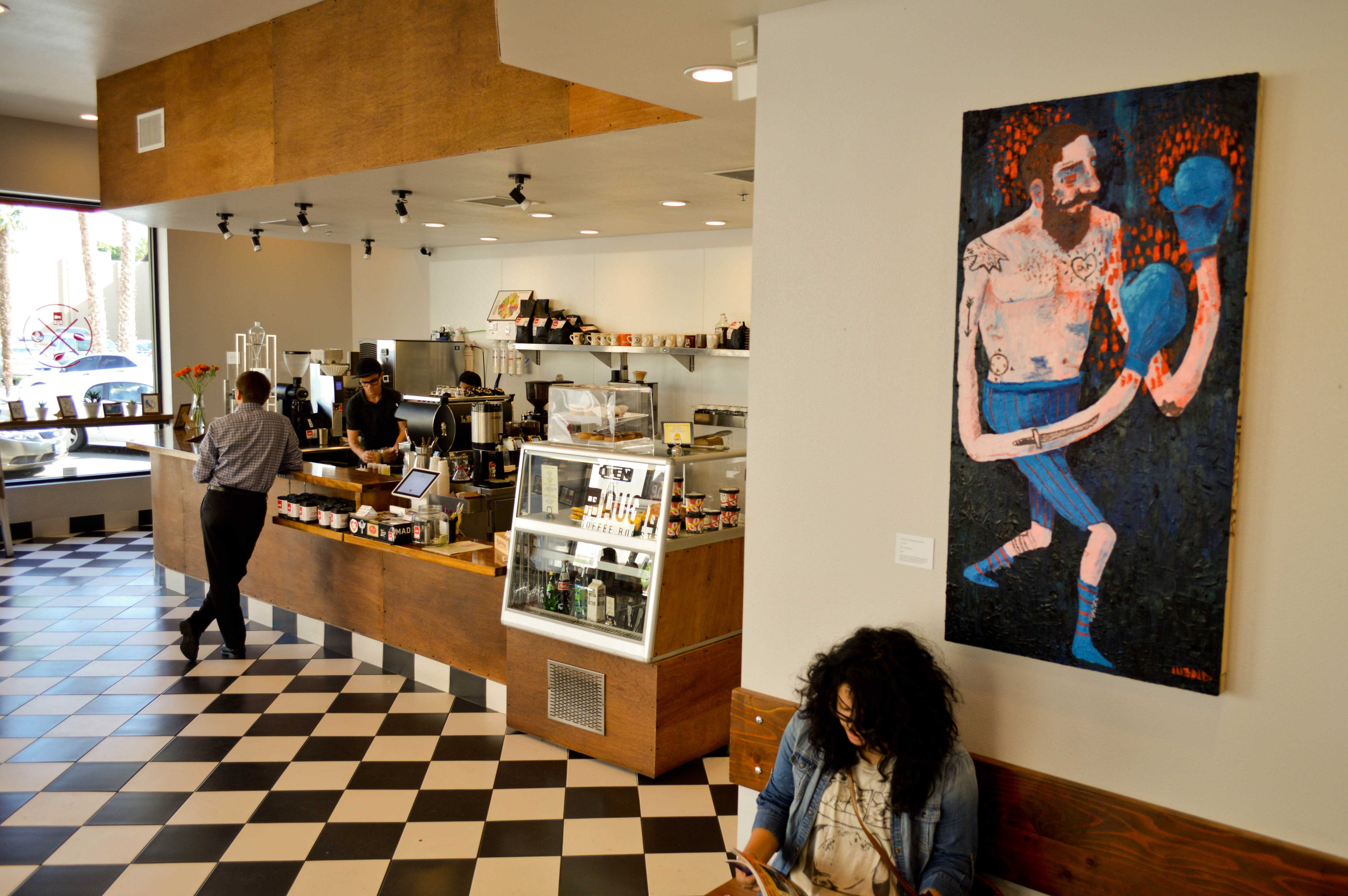 Photo by John Villanueva On Display: Geoff Gouveia’s art hangs inside of  Augie’s coffee house on 12th St and Lemon St. in downtown Riverside. A mural also adorns the wall facing 12th St. 