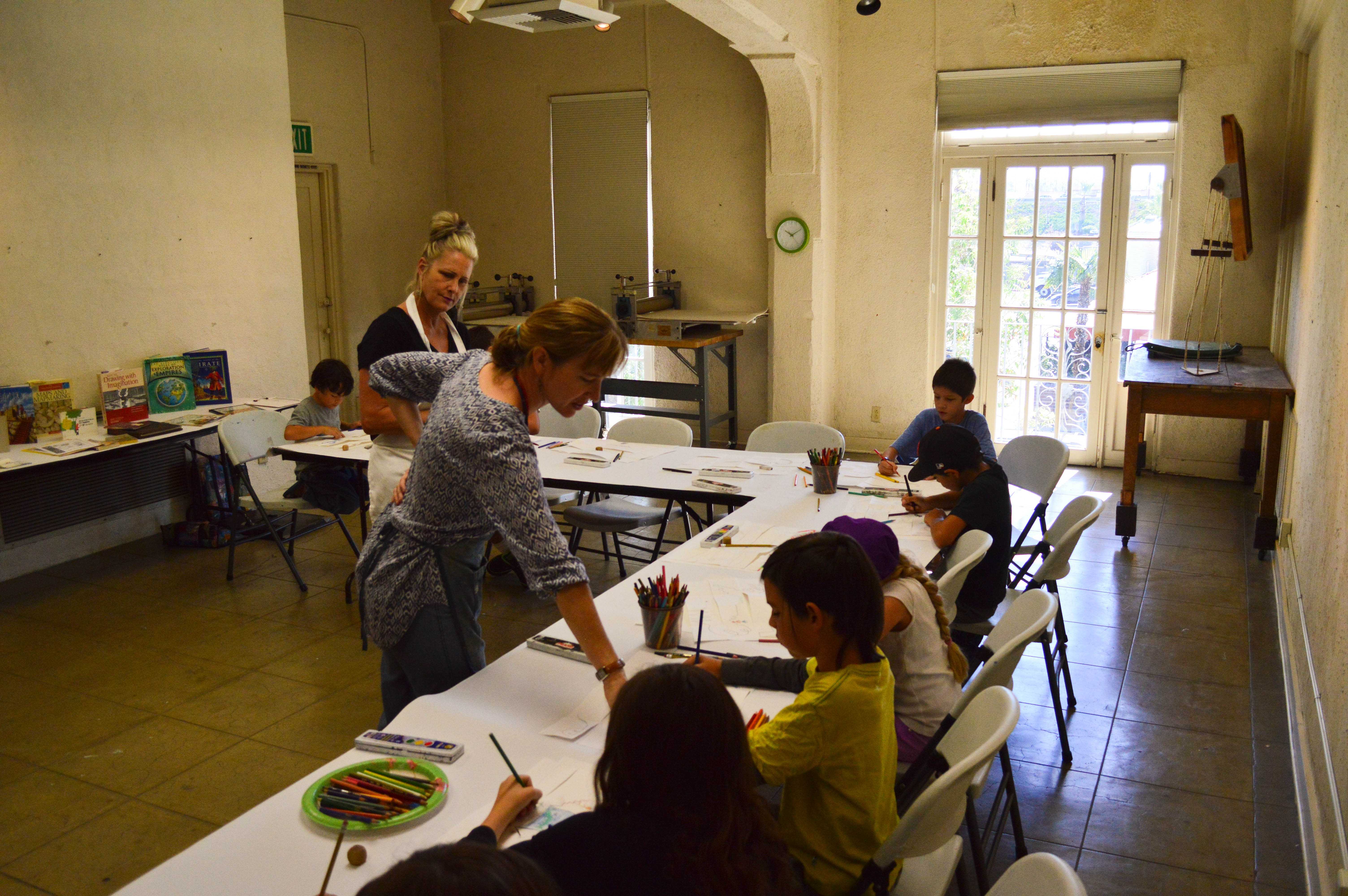 Kelly Rider teaches children art in the Riverside Art Museum with the assistance by Sally Mazzetti.