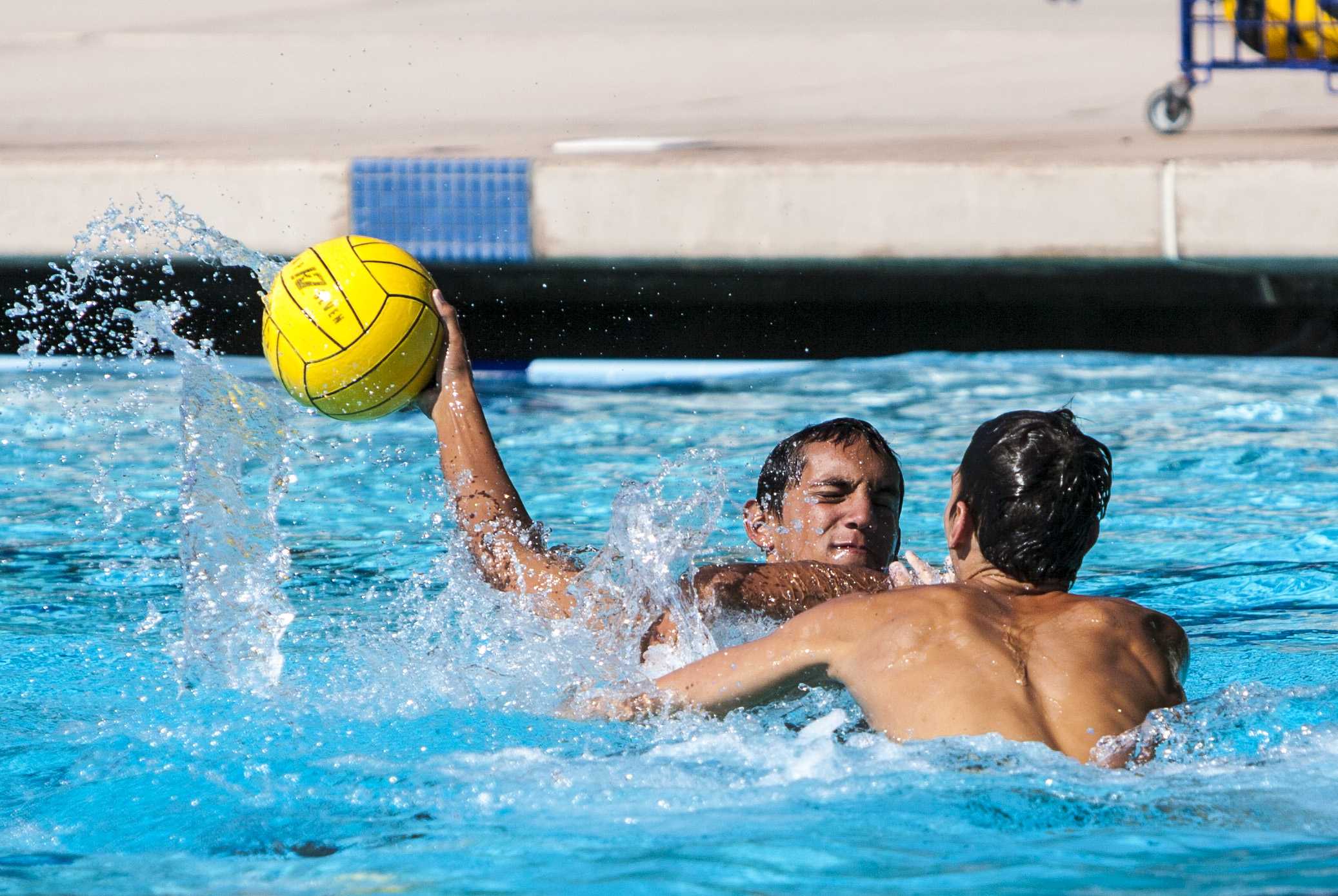 H20: During a scrimmage at the Riverside Aquatics Center, Riverside City College water polo player Joey Valdez (left) attempts a shot against teammate Chris Frazee.