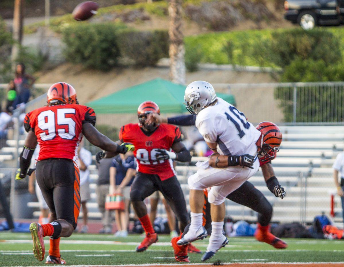 DEFENSE: Sophomore Linebacker Jonah Moi breaks through the offensive line for a breathtaking tackle against El Camino College quarterback Joey Notch on Oct. 4. 