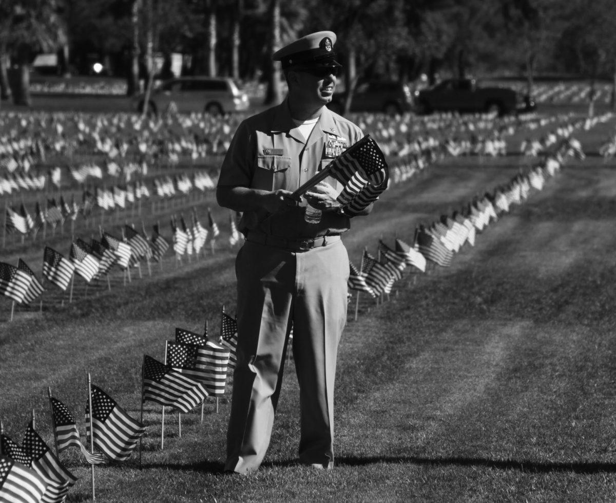 John Villanueva / Staff Photographer
Paying respect: Navy Chief Mineman Michael Pittenger donates his time in uniform placing flags at the graves of servicemen in Riverside National Cemetery Nov. 8. 