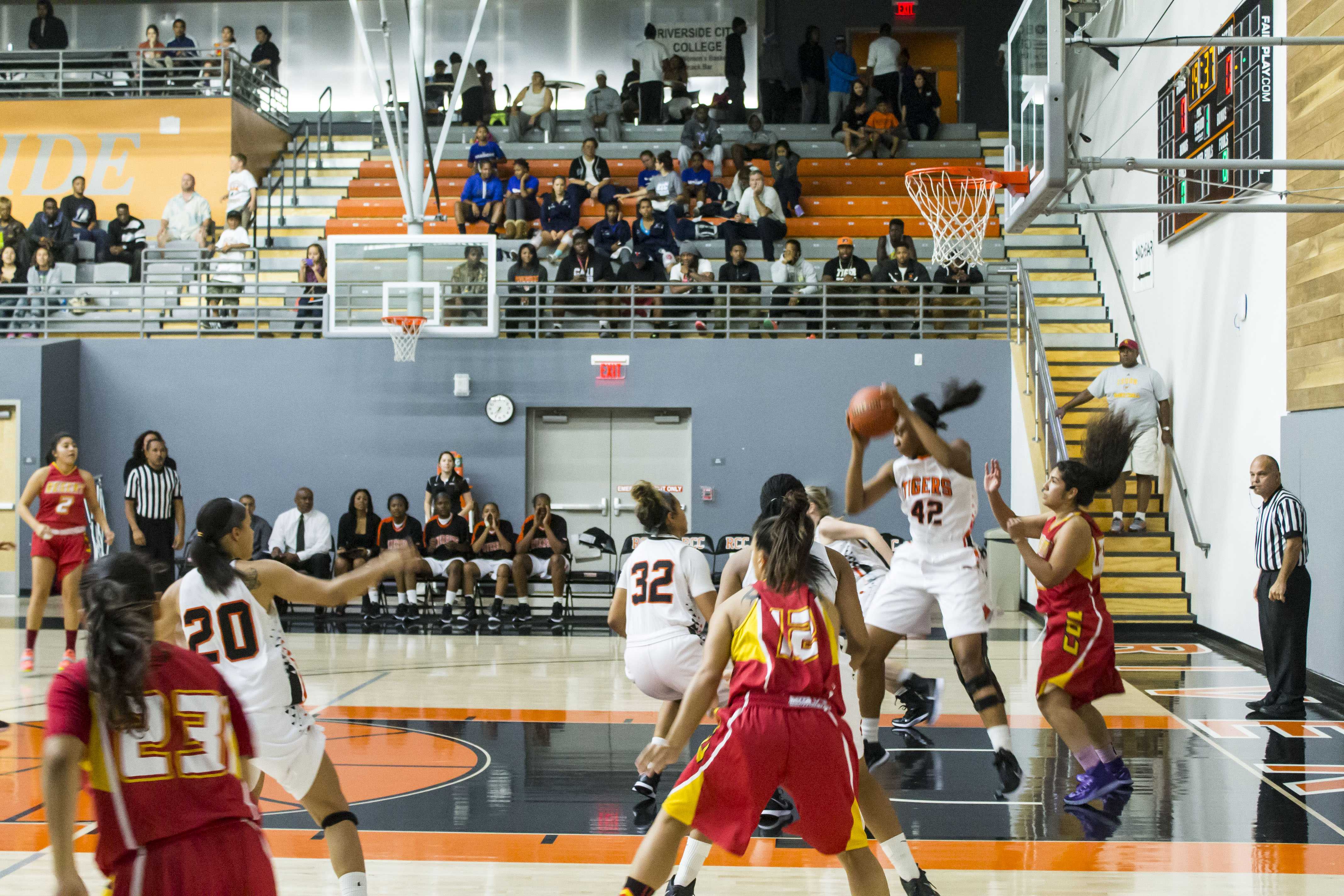 luis solis/  Photo editor rebound: Tigers foward-center No. 42 Tori Mitchell catches a rebound off the opponents rim College of the Desert during the opening round of its Inaugural Earning Our Stripes Tournament.  