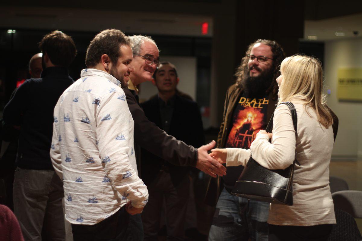 The Synchromy composers collective talking among each other after the Outpost Concert Series in Riverside Dec. 2. (Michael Isberto | Staff Photographer)