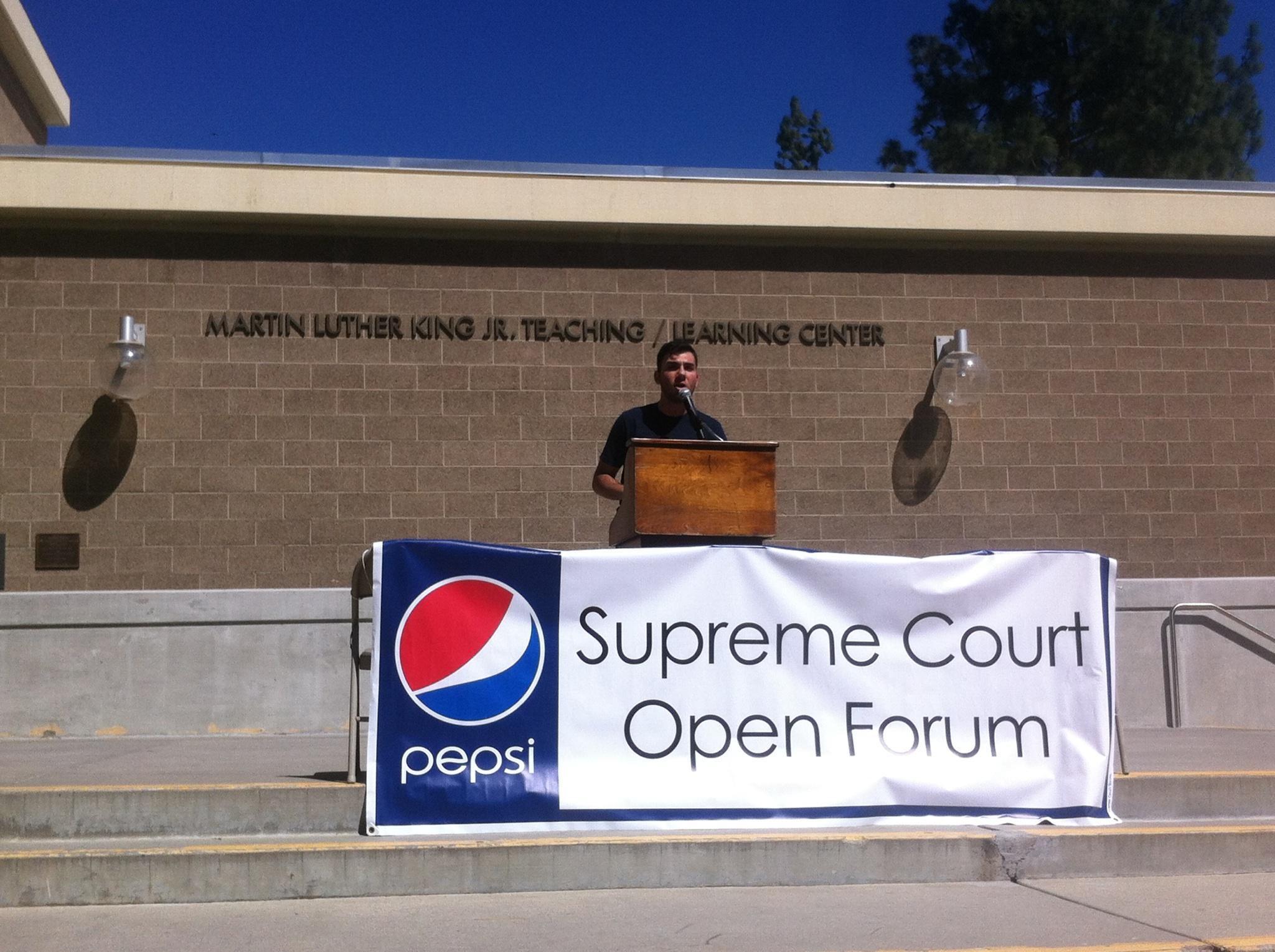 Sammie Ayoub, Supreme Court pro-tempore of ASRCC, informs students of the significance of the RCCD student trustee position, at an open forum held March 12 on the steps of the Martin Luther King Jr. Teaching/ Learning Center.