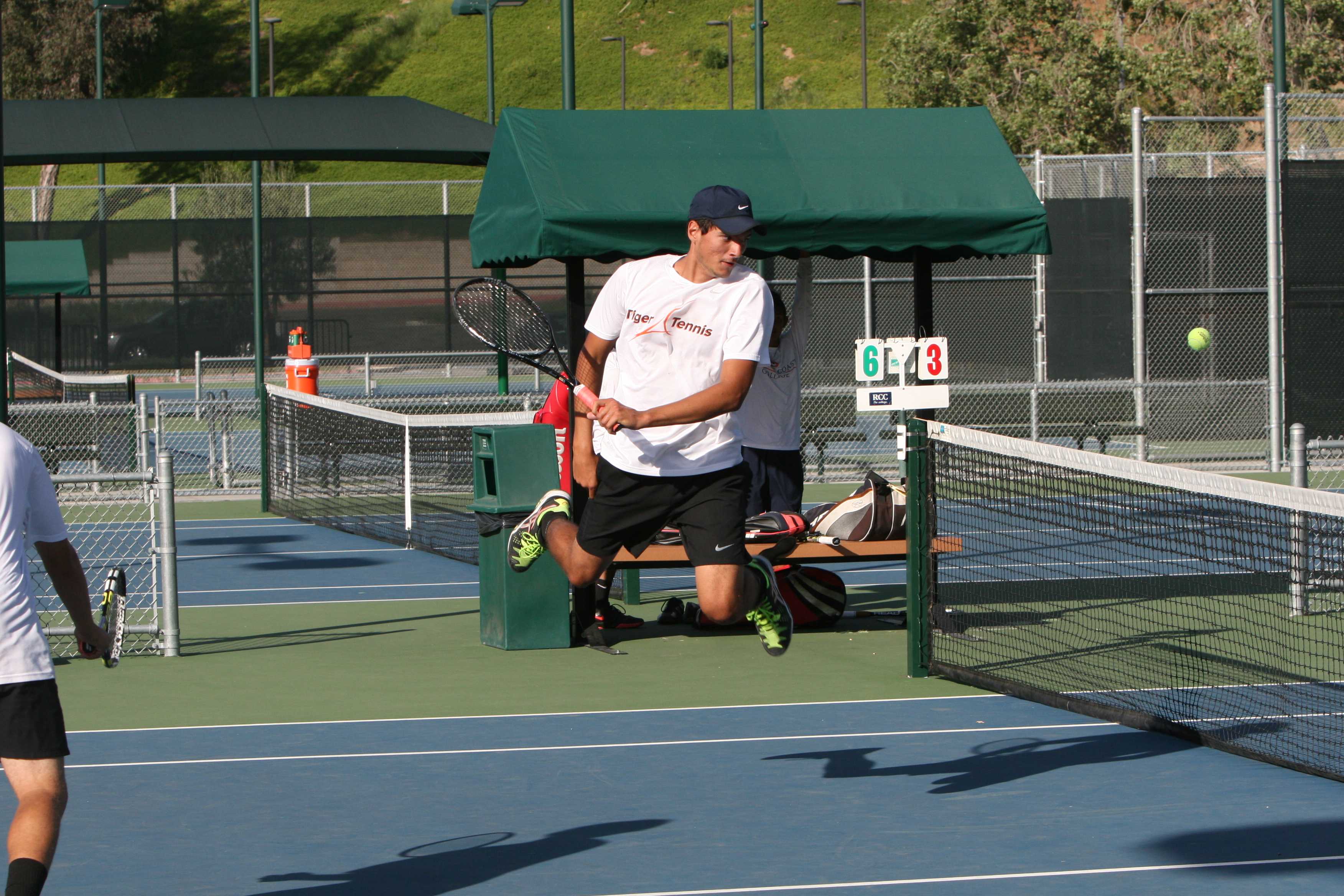 RCC freshman Antoine Voisin jumps high in an attempt to return the ball in his doubles match against Orange Coast on March 31