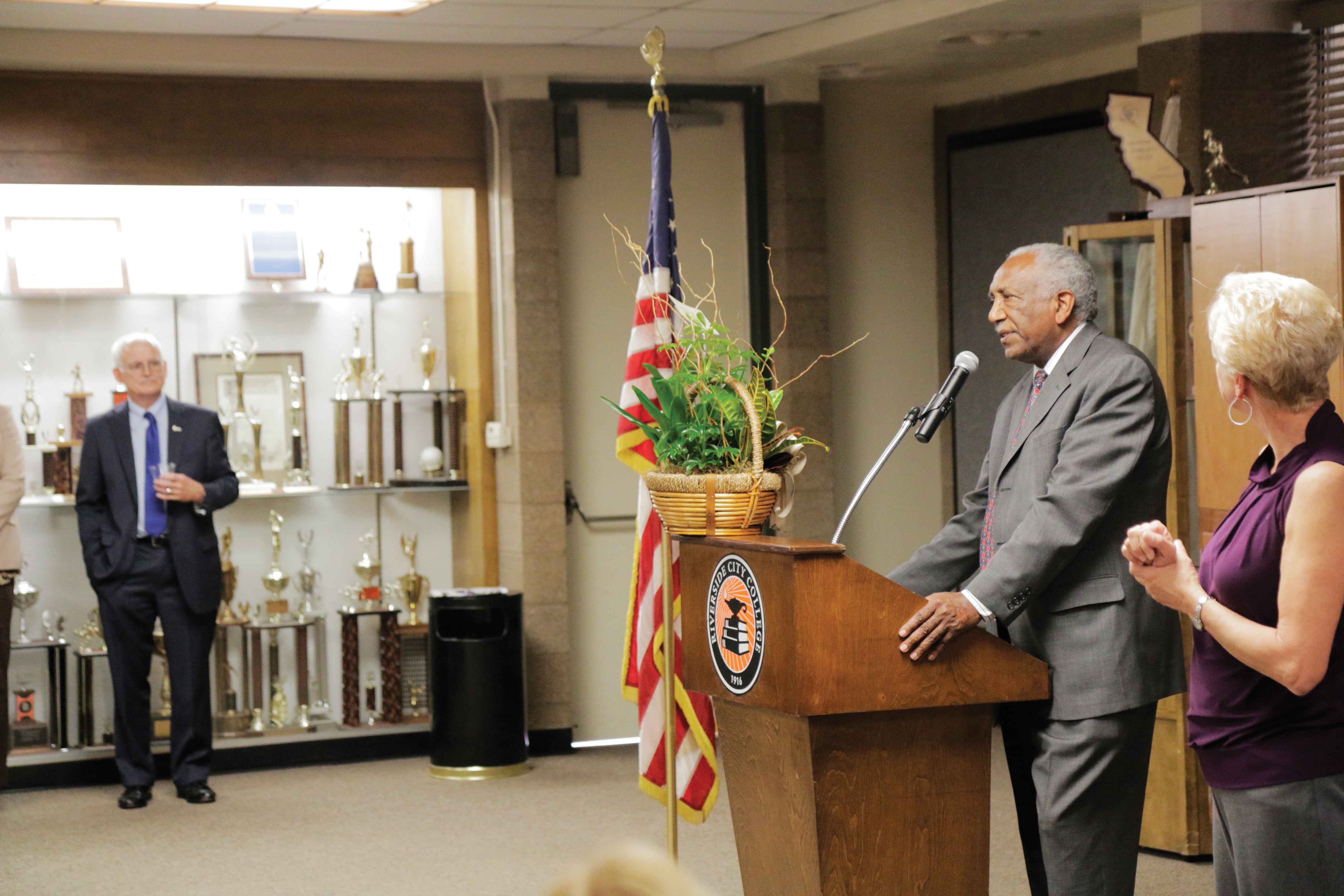 Chancellor Michael Burke looks on as Isaac speaks at a reception following his being appointed to RCC president. 