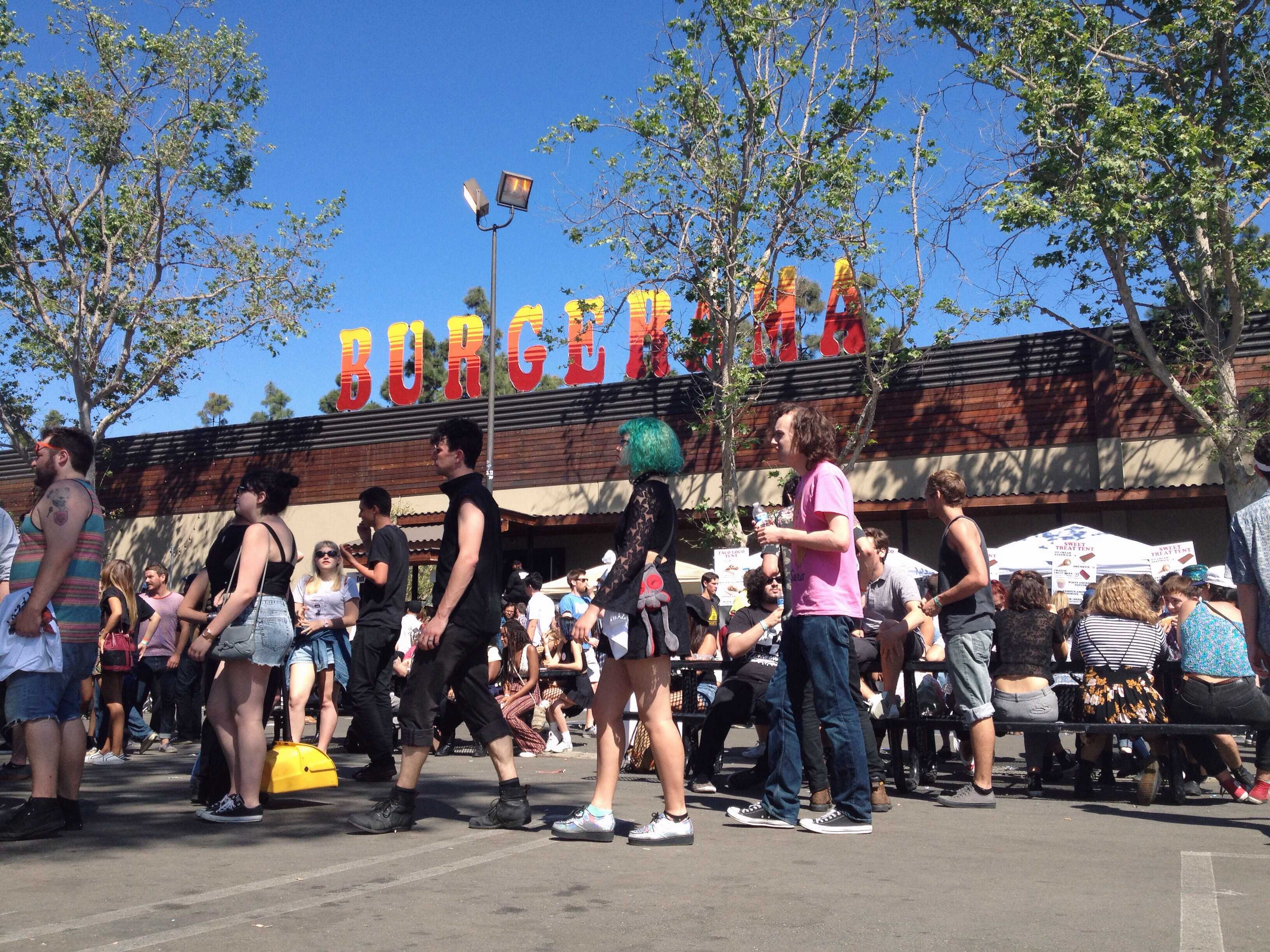 Burger fans caught snacking. The mini festival had plenty of food vendors. Tacos, hot dogs, and of course burgers.