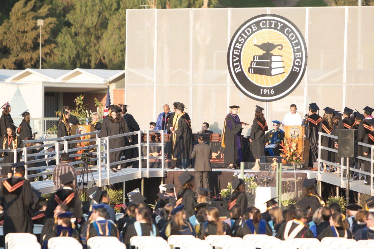 Students shake hands with faculty after recieving their certificate. Alexis Naucler | Viewpoints