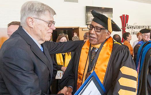 Celebrate: RCC’s new president, Wolde-Ab Isaac, shakes the hand of Irving Hendricks former RCCD interim chancellor, at the Presidential Investiture held in Landis Auditorium on Oct. 12.
Photo courtesy of RCC.edu