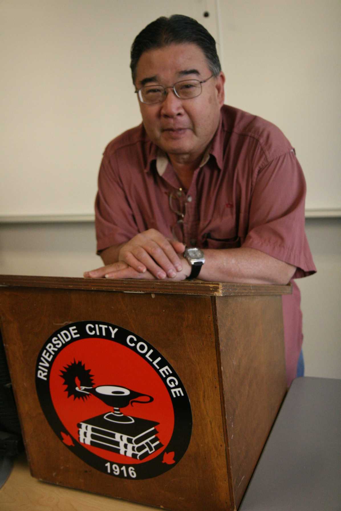 Ron Yoshino, RCC professor emeritus, stands behind a lectern he taught from during his time at the college. 