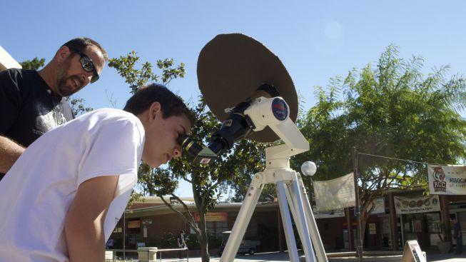 RCC Astronomy professor Scott Blair helps  students and centennial event guests use a solar telescope to safely look into the sun. 