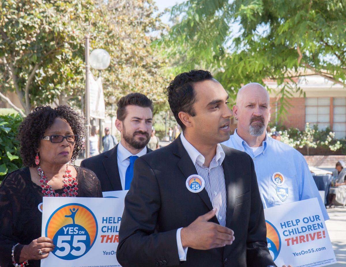 Representatives from local school districts gather while Dr. Angelov Farooq explains the significance of Prop 55 during a press conference.  (Daniel Francis | Viewpoints)