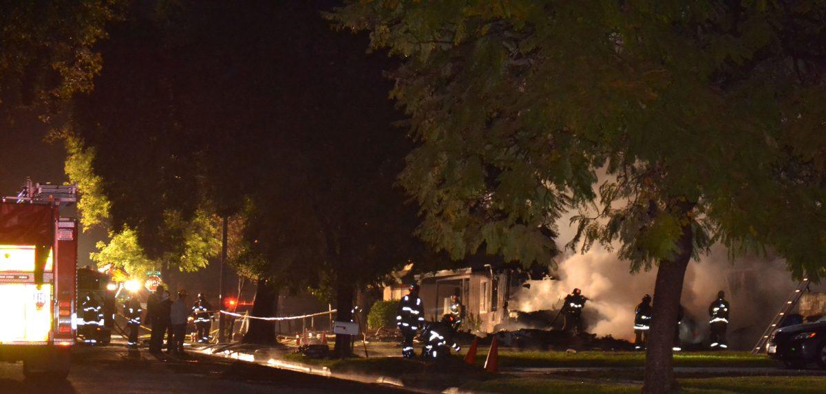 Firefighters get the blaze under control after a plane crashed into houses on Rhonda Road in Riverside on Feb. 27. (Chris Edson | Viewpoints)