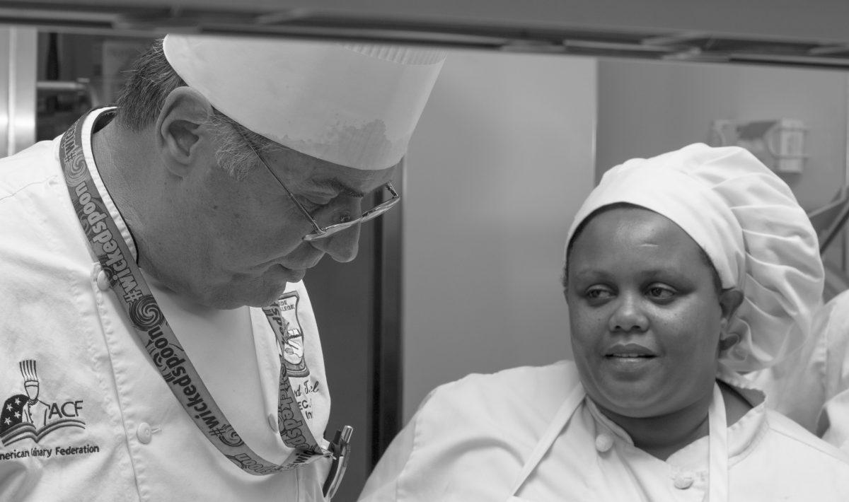 Chef Richard Gabriel assists (name missing as of Oct. 30 2017) in cullinary instruction in the RCC cullinary academy kitchen.