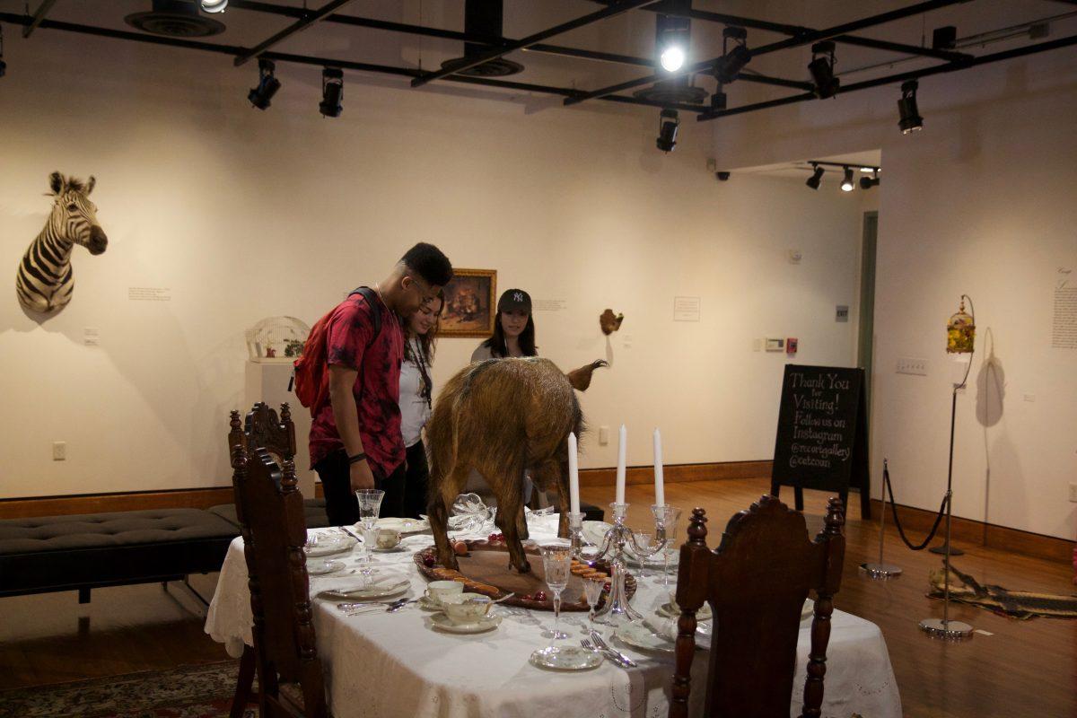 RCC students including Rohan Reid and Georgina Shnani view Catherine Coan’s “Prix Fixe” in the RCC Quad Art Gallery on March 20. Imari Rede | Viewpoints