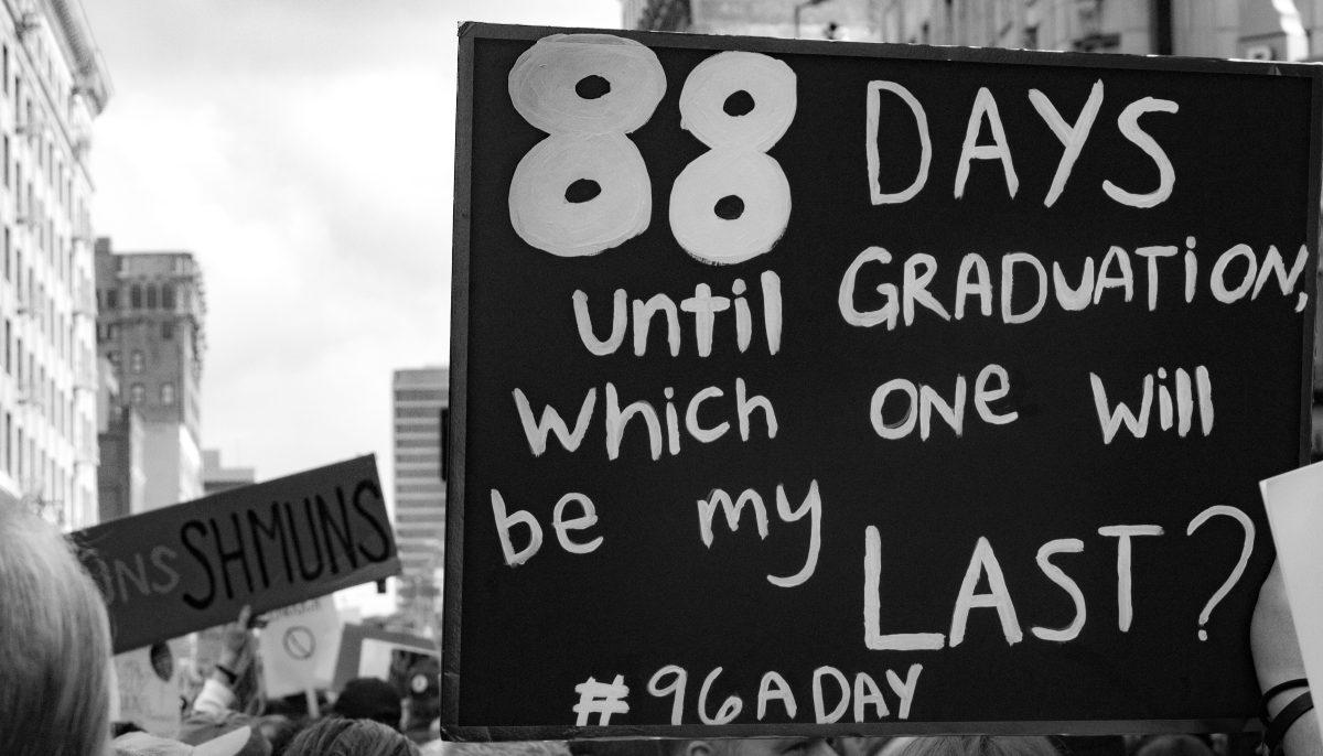 A protester holding up a sign with "#96ADay" that represents the number of people who die from gun violence in America. (Elizabeth Tovar Llamas | Viewpoints)