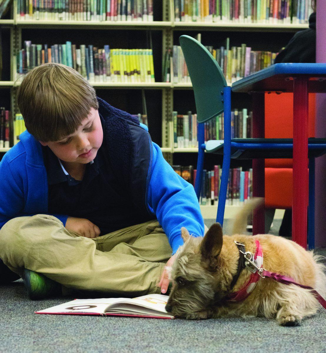 Benjamin Schmit reads to Piper during the La Sierra Library’s monthly B.A.R.K event on March 20, 2019.

Jacob Quezada | Viewpoints