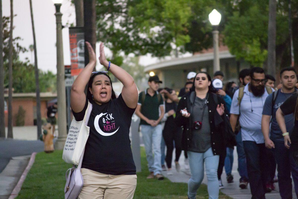 Keynote speaker Elizabeth Ayala chants “Take back the night” as she marches alongside RCC students.