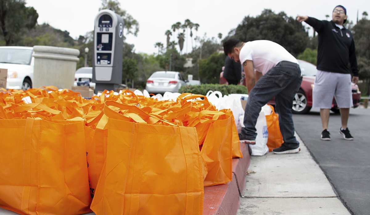 The RCC Tiger Pantry hands out free food to students in a grab and go fashionk with the help of members from ASRCC, RCC Athletics, Student Services and more on Mar. 18. A total of 545 bags were prepared with canned and fresh foods.