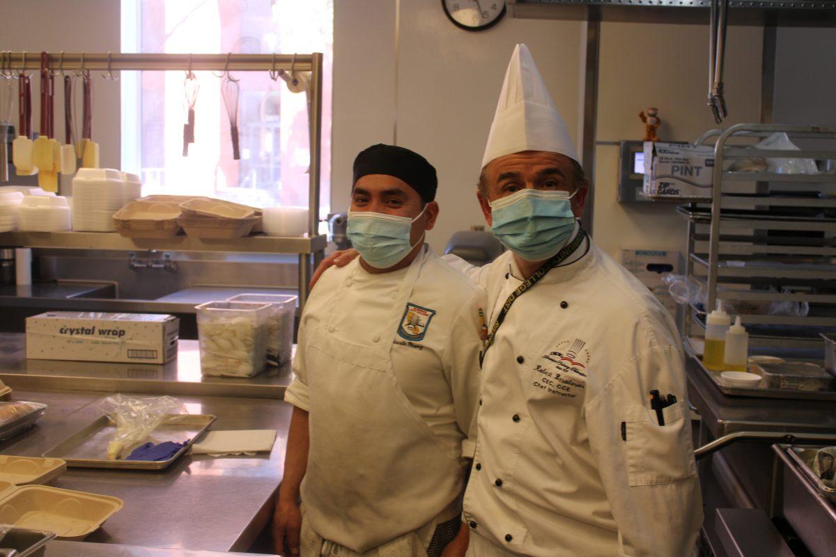 Chef Robert Baradaran puts his arm around Riverside City College culinary studen Eduardo Chavez in the RCC Culinary Academy kitchen March 17. (Timothy Lewis | Viewpoints) 