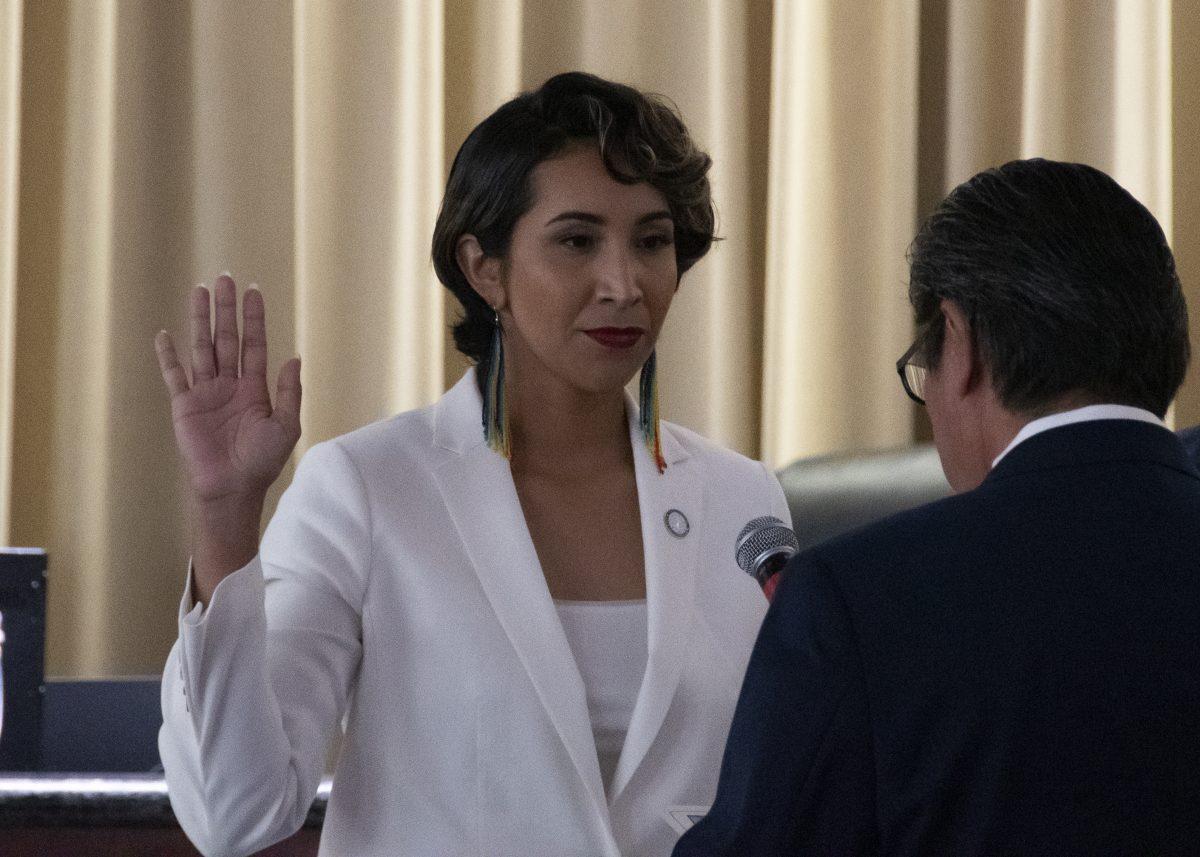 Clarissa Cervantes, left, raises her right hand and takes the Oath of Office with former ward 2 councilmember Andy Melendrez July 13. (Leo Cabral | Viewpoints)