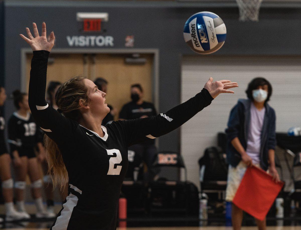 Hailey Gray, setter, serves the ball to the Cerro Coso team during the first match on Sept. 9. 