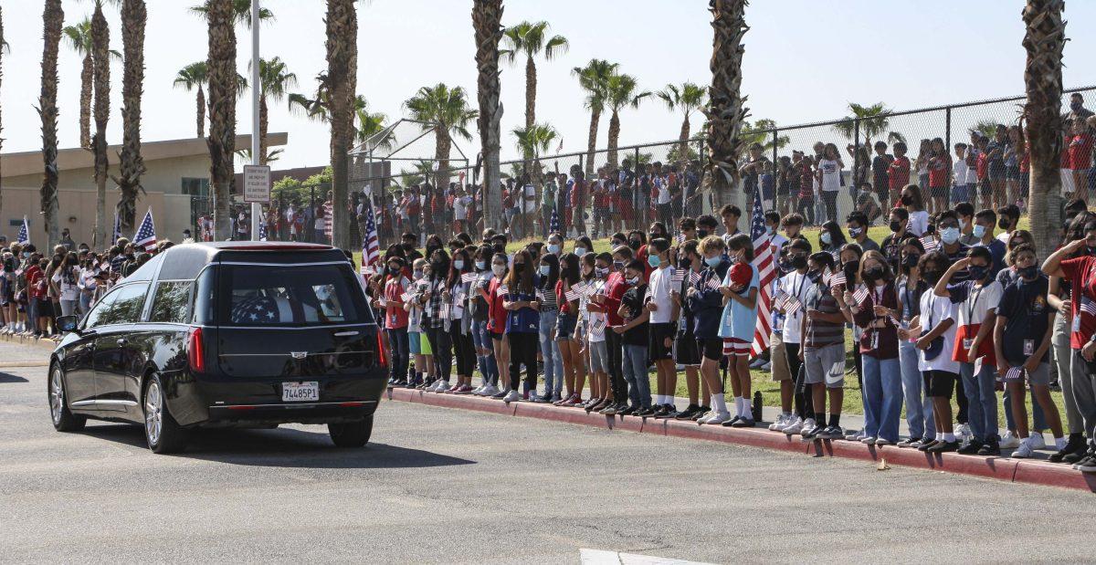 Hundreds of children line the fence at Amelia Earhart Elementary School while just as many students from John Glenn Middle School assemble on the street to honor Marine Cpl. Hunter Lopez as his motorcade passes by Sept. 17 in Indio. (Joyce Nugent | Viewpoints)