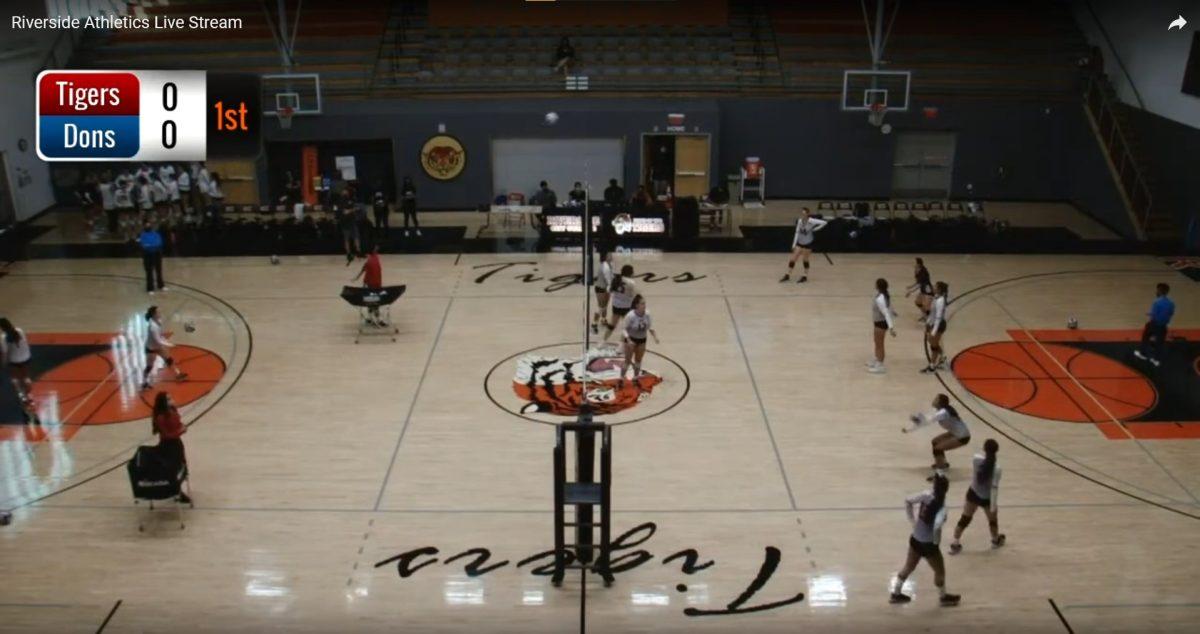 A screenshot of Riverside City College Athletics live stream coverage of the RCC versus Santa Ana women's volleyball match shows the Tigers practicing on their home court. (RCC Athletics YouTube)