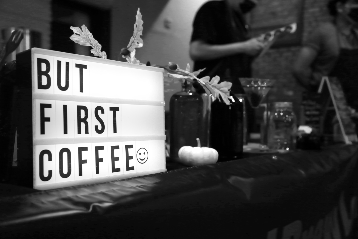 A light up sign displays "but first coffee" on Louis Espinoza and his brother Josué Ticas' table at the Riverside Arts Walk  Oct. 17.