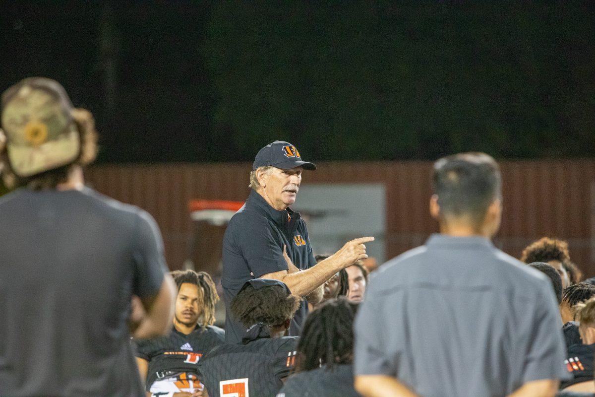 RCC Head Coach Tom Craft talks with the football team following their 49-3 victory over Chaffey. The team now shifts their focus to the postseason. (Brian Calderon | Viewpoints)