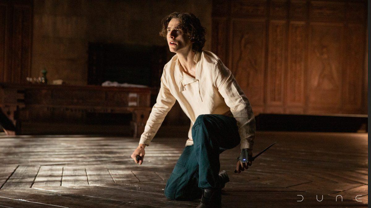 Paul Atreides (Timothee Chalamet) holds two knives in his hands. (Photo courtesy of dunemovie.com)