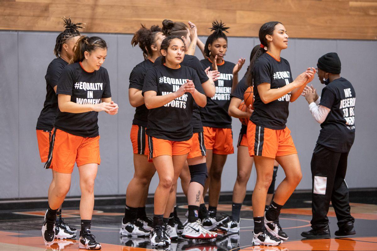 The Riverside City College women's basketball team breaks from a huddle and walk toward the sideline. The team all wear t-shirts expressing solidarity to women's athletics after alleging that the college has discriminated against them. (Daniel Hernandez | Viewpoints)