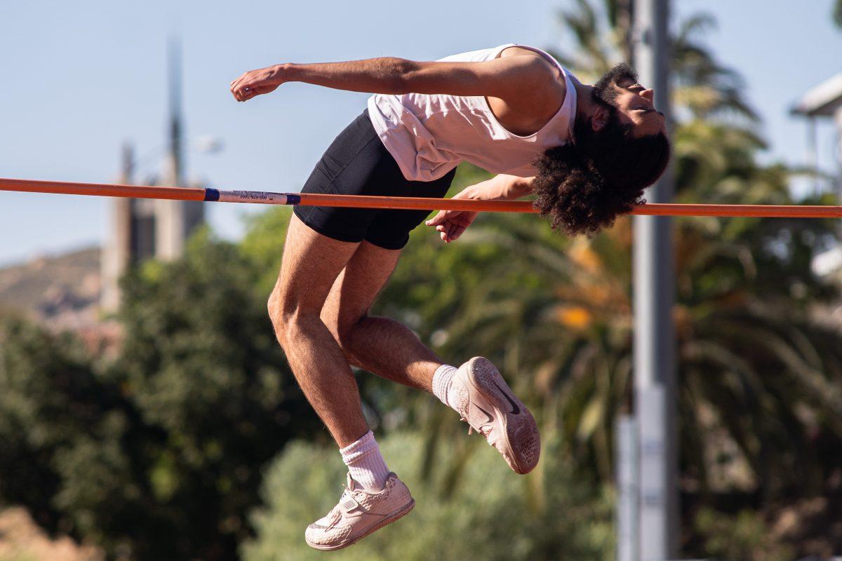 Darius Hill leaps over the pole and earns first place in the high jump event at the RCC Open on March 18. (Daniel Hernandez | Viewpoints) 