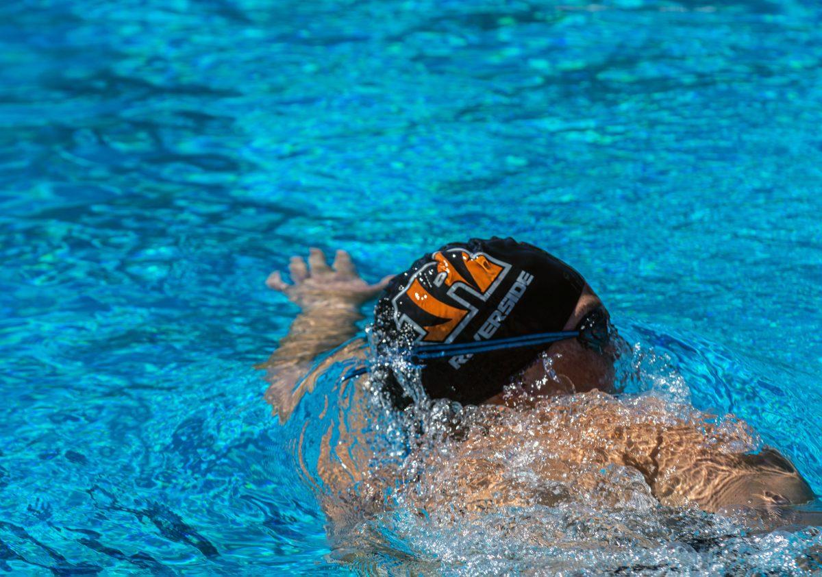 Riverside City College swimmer swims laps in the practice lanes while waiting for the next heat at the RCC Aquatics Complex on March 11 at the RCC Invitational.