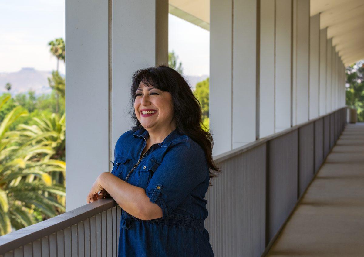 Patty Ramirez, Riverside, leans on the railing of the 4th floor of the Math and Sciences building overlooking the Dr. Charles A. Kane Student Services and Administration building on March 26.

Ramirez is a non-traditional student at Riverside City College and juggles classes with being a mom, a wife and teaching a Zumba class.  She's studying to become an Oncology Navigator and hopes to be able to help women dealing with breast cancer through their journey. Photo By Stephen Day, Viewpoints.