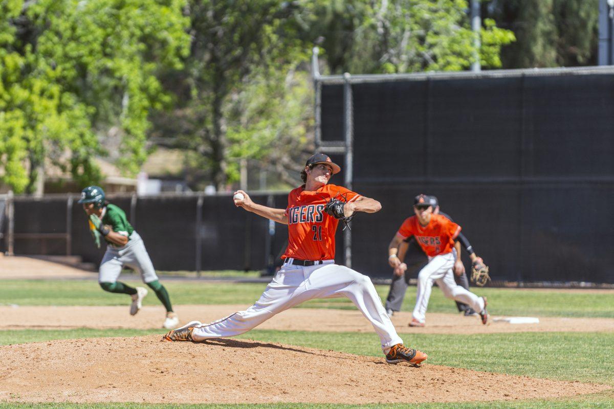 Riverside City College Tiger, David Butler, 21, stretches into his pitch while Golden West Rustler, Zech Samayoa, 13, starts his unsuccessful attempt to steal second base. Tigers hosted the Hustlers with a 10-1 victory on April 7. (Stephen Day | Viewpoints)