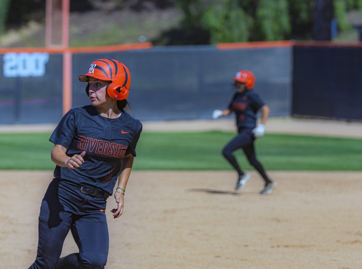 Riverside City Tiger, Sarah Franco-Colis, INF, checks the outfield to see if rounding third for home is an option during the April 20 game against the Orange Crest Pirates. Photo taken by Stephen Day, Viewpoints.