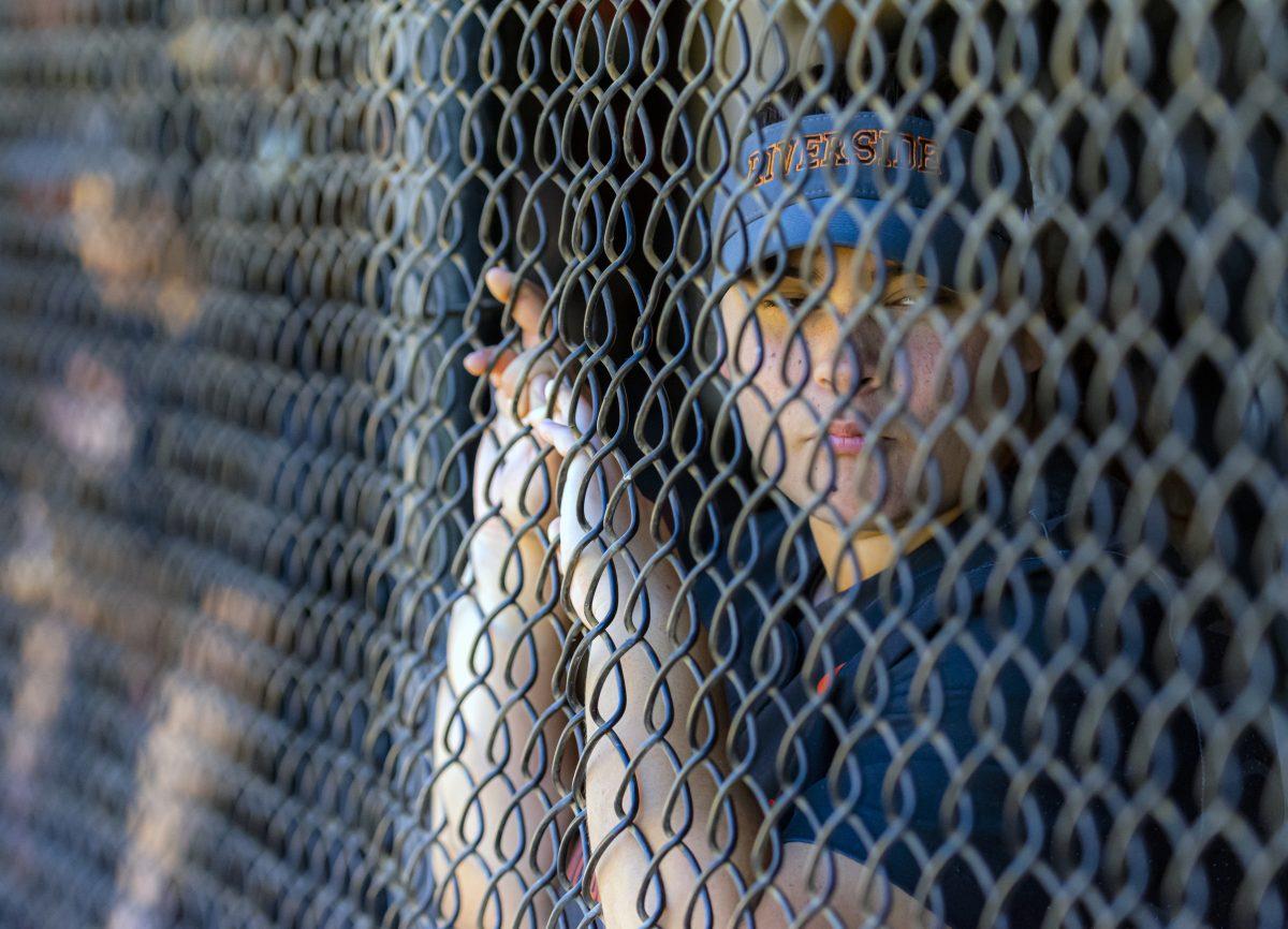 Riverside City College Tigers wait for the game to get started again, while the team doctor tends to an injured player during the game against Orange Crest Pirates on April 20.  Photo by Stephen Day Viewpoints.