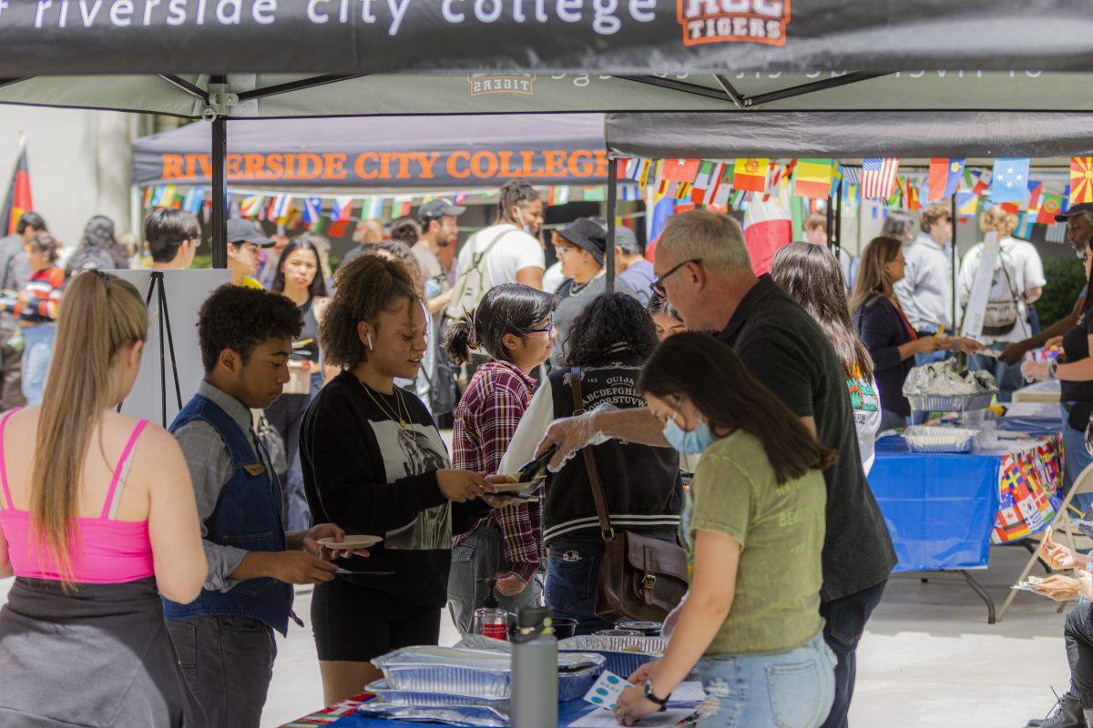 Students wander around and sample different cuisine from each of the booths at the Taste of Nations, an event featuring foods from many different parts of the world, being held at the Quadrangle building at Riverside City College on April 26.  Photo By Stephen Day.