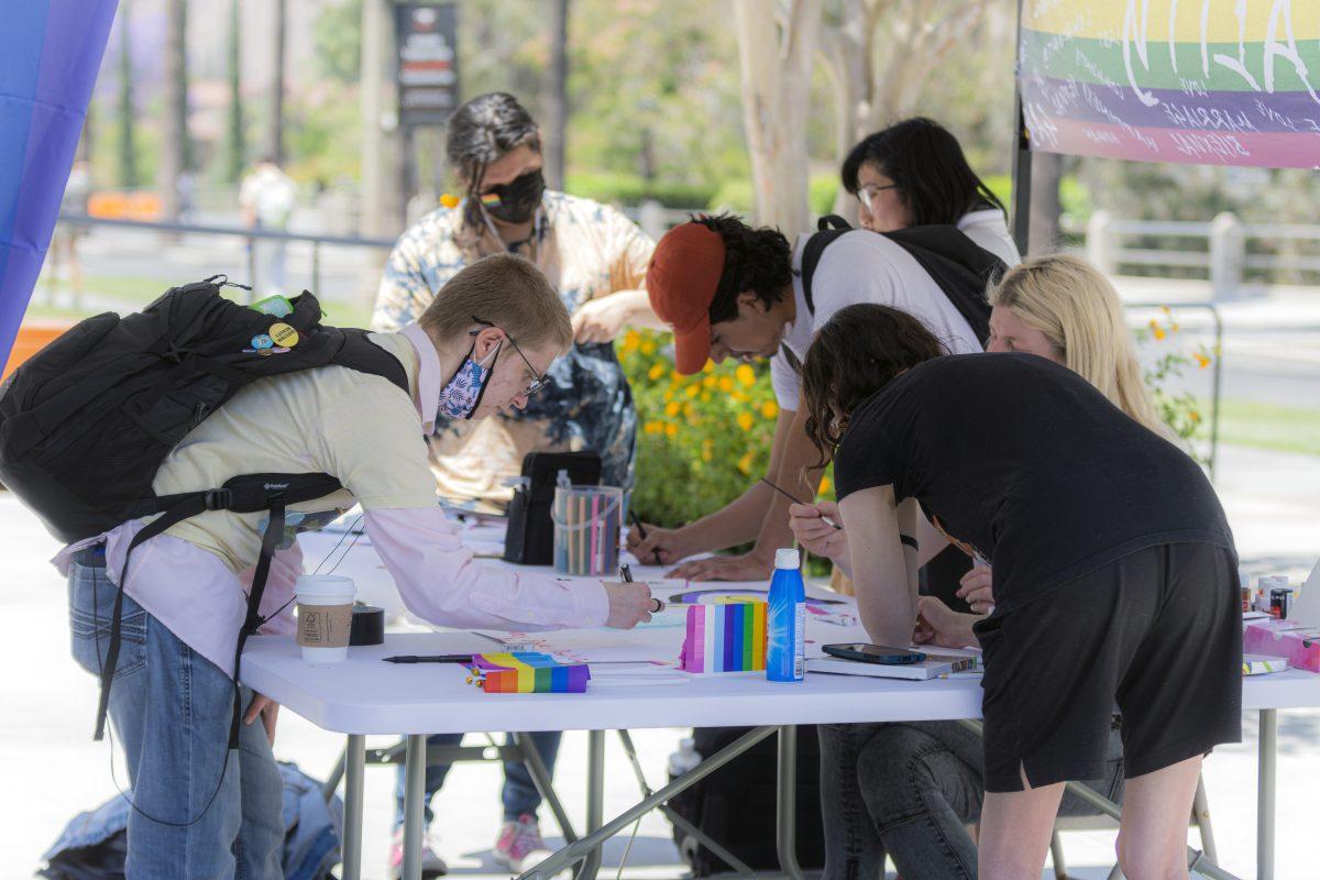 Riverside City College students express their pride by helping create a Pride mural on May 24, just one of the many pride events going on all month at RCC. (Stephen Day | Viewpoints)