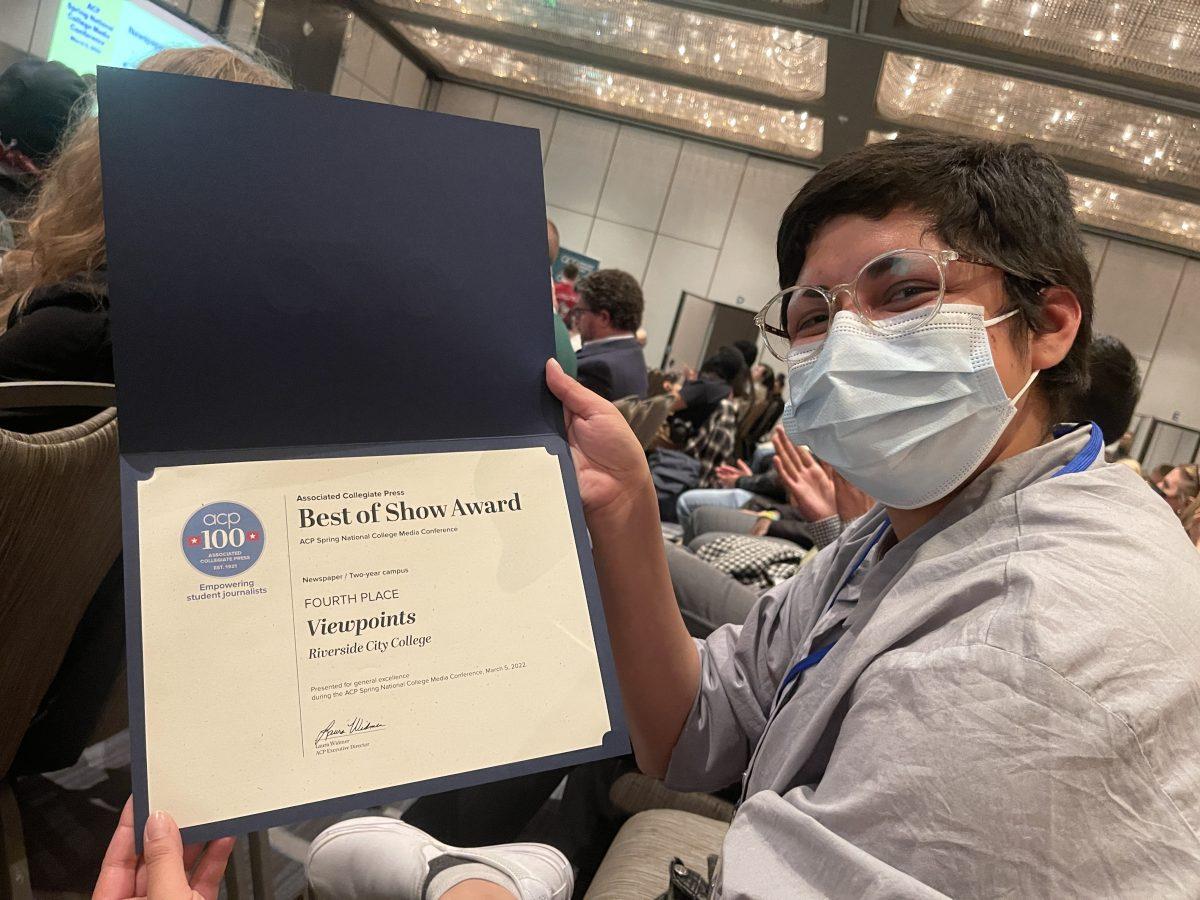 Editor-in-chief Leo Cabral holds up an Associated Collegiate Press Best of Show Award during the Journalism Association of Community College conference March 5. John Michael Guerrero | Viewpoints