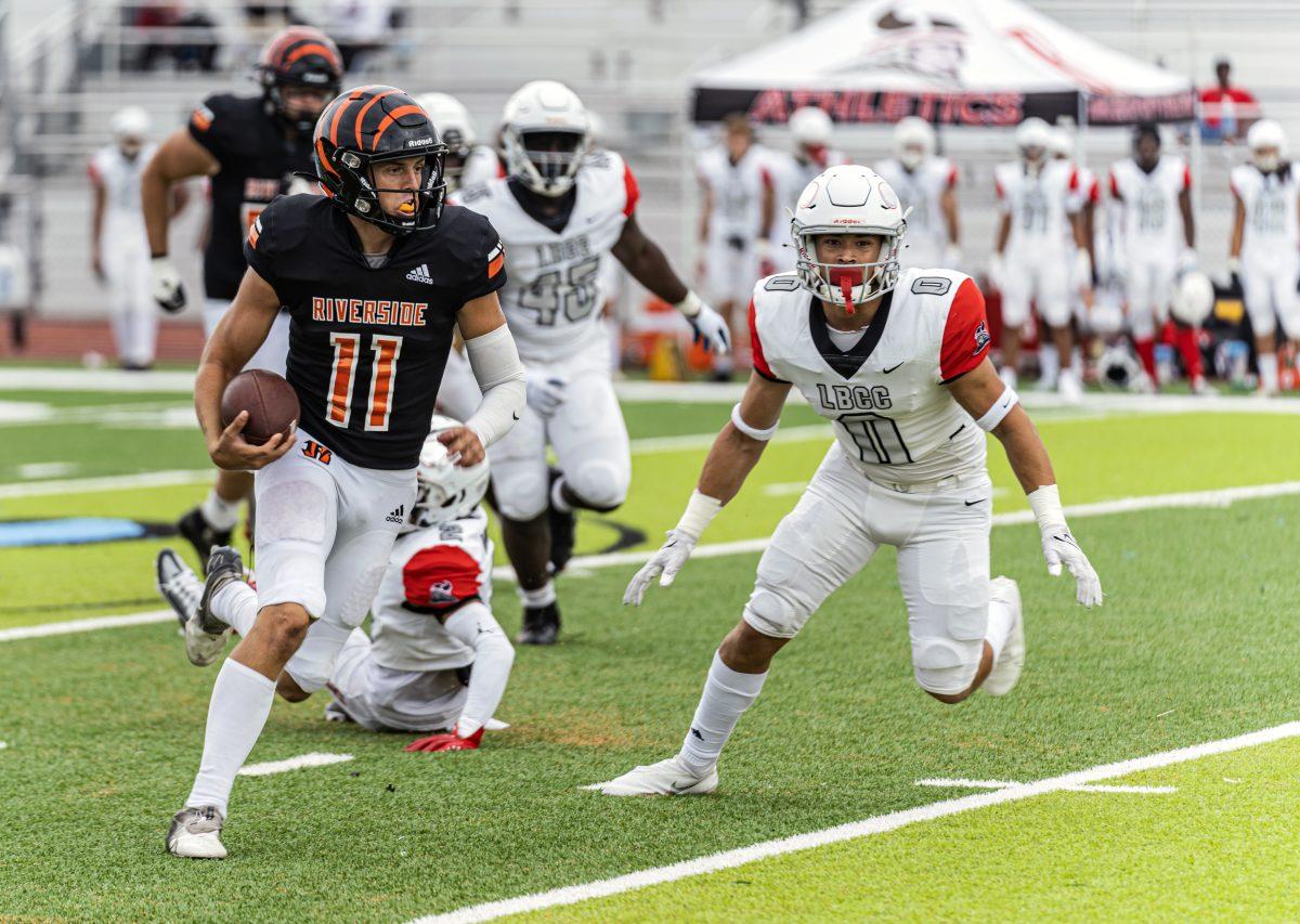 Riverside City College Tiger Jake Retzlaff, 11, sees an opening in the line, and decides to run the ball downfield.

The Tigers would defeat the Long Beach City College Vikings 48-20 on Sept 10 at Ramona High School Field.

Photo by Stephen Day, Viewpoints.