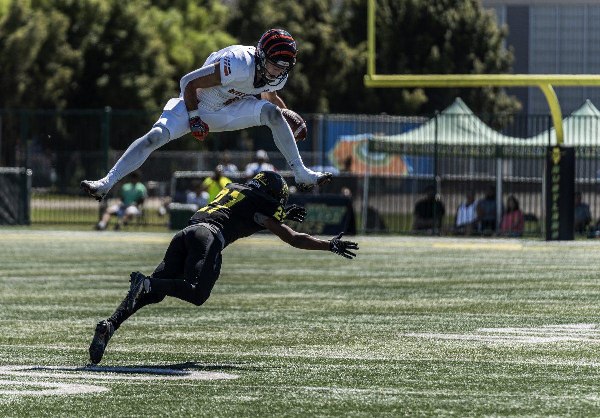 Reggie Retzlaff leaps over Kentrelle Omar to avoid the tackle and gets the first down.

Tigers remain undefeated after beating the Rustlers 58-21.

Photo by Stephen Day, Viewpoints.