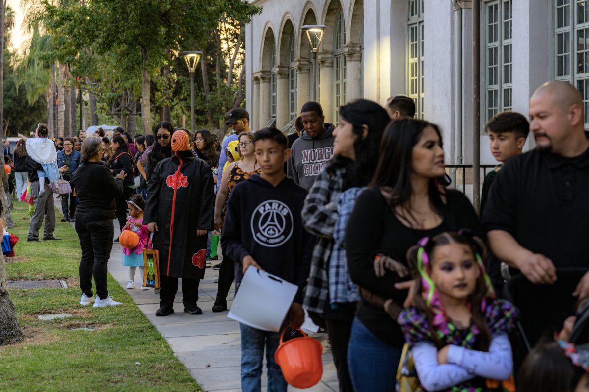 Parents and children in costume from the Riverside community line up all around the Quadrangle building, waiting to get inside for the annual HalloweenTown event on Oct. 28 at Riverside City College.

HalloweenTown brings college clubs together to decorate rooms in the Quadrangle to hand out candy to trick or treaters as well as the music department playing live music, a funnel cake vendor, and a photo booth from the Photo Club.

Photos by Stephen Day | Viewpoints